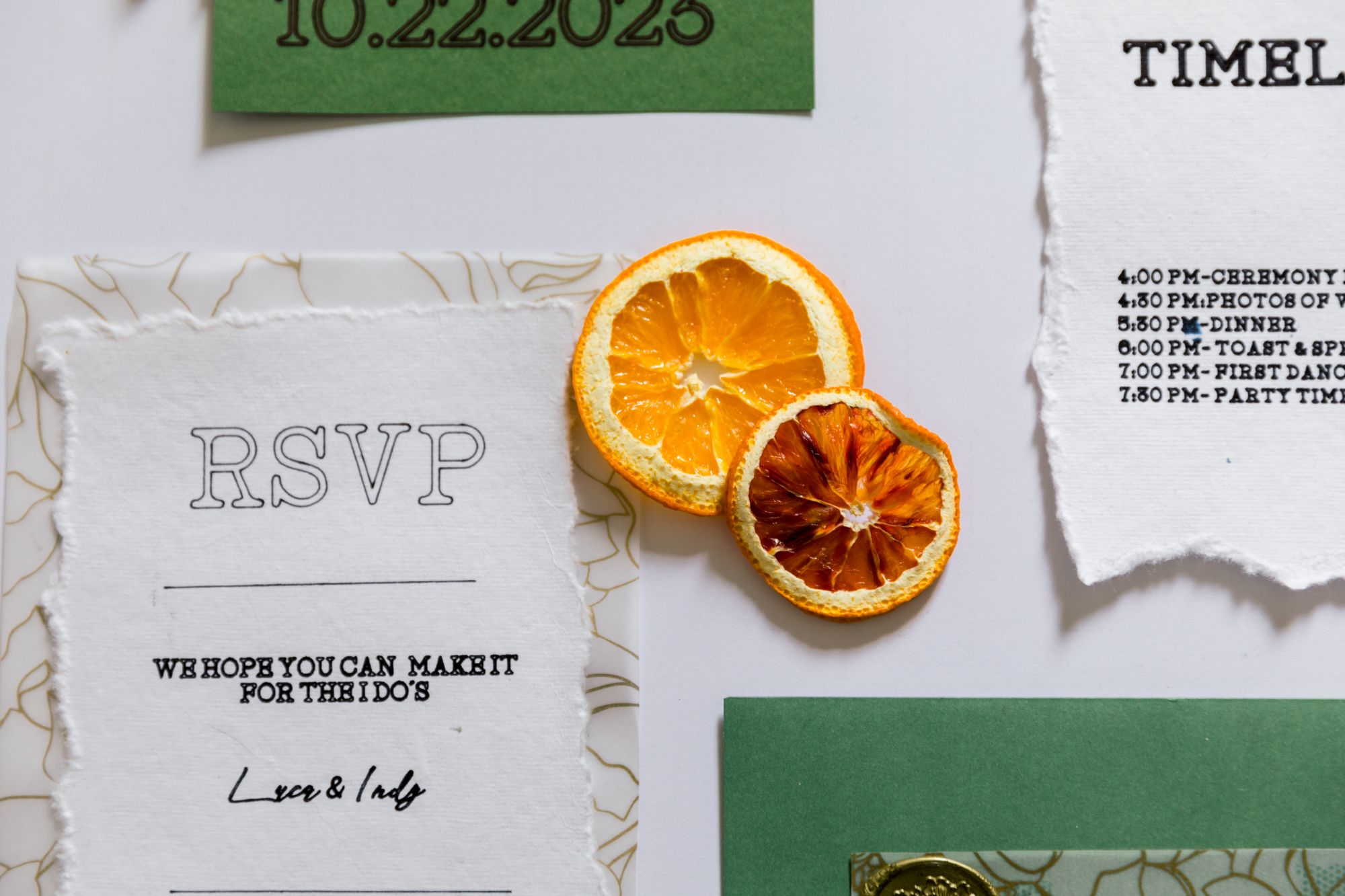 Wedding RSVP card and timeline stationery flat lay with dried orange slices