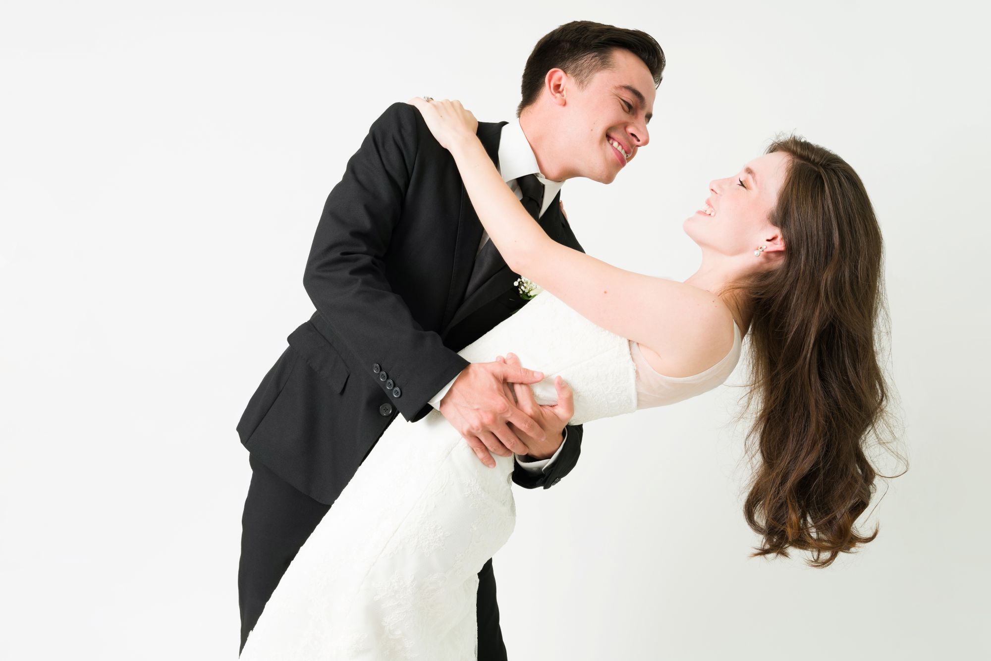 Bride and groom sharing a joyful dip during their wedding first dance